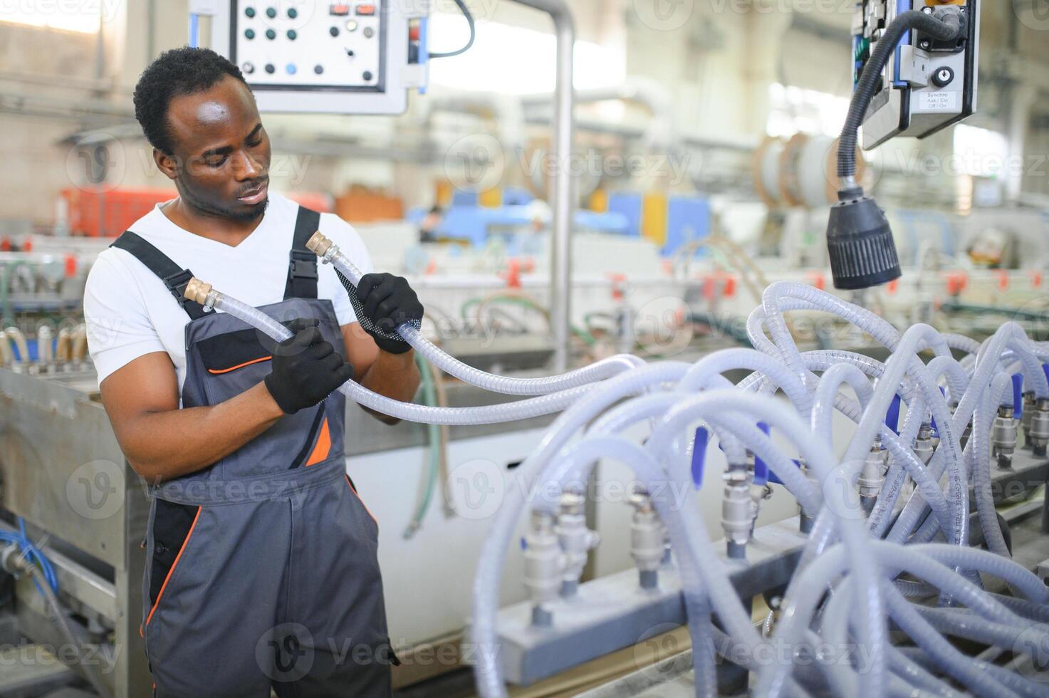 An African-American male worker in a plastic window frame factory photo