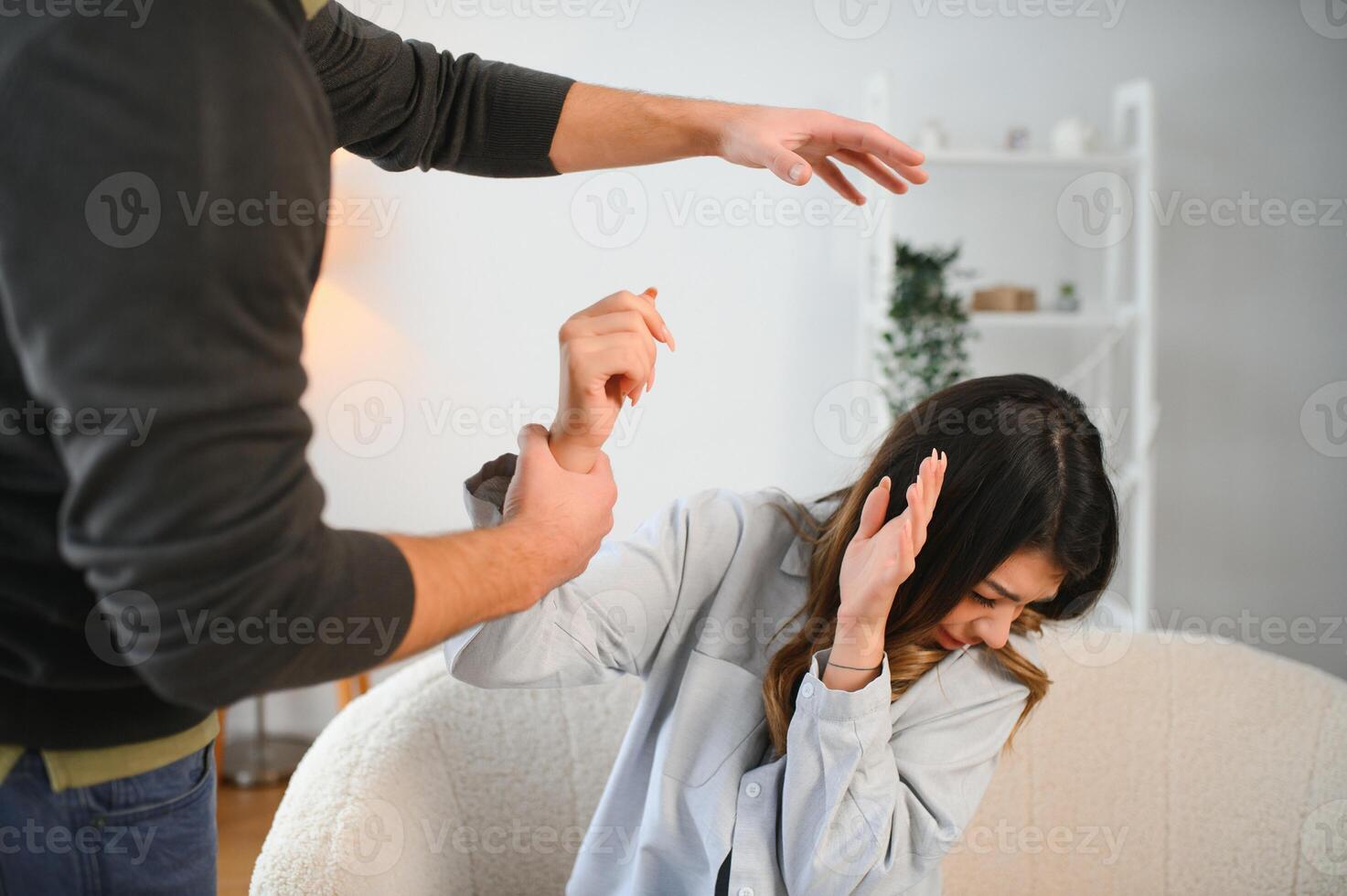 An agitated and upset husband shouts and looks at his wife, a quarrel between spouses. Family misunderstanding, quarrel photo