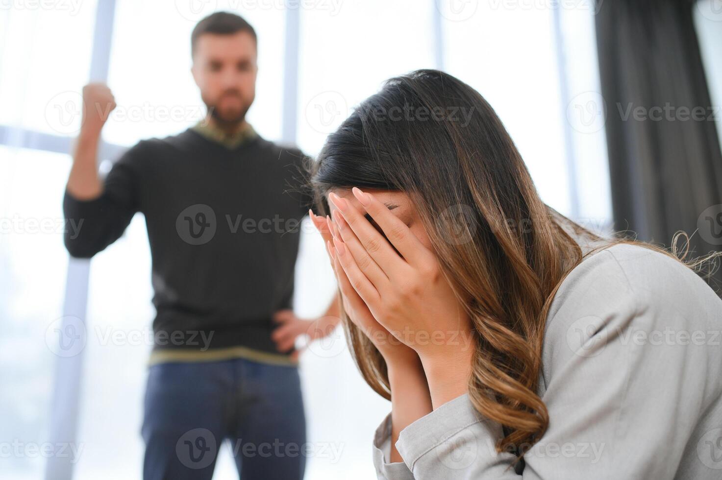 An agitated and upset husband shouts and looks at his wife, a quarrel between spouses. Family misunderstanding, quarrel photo