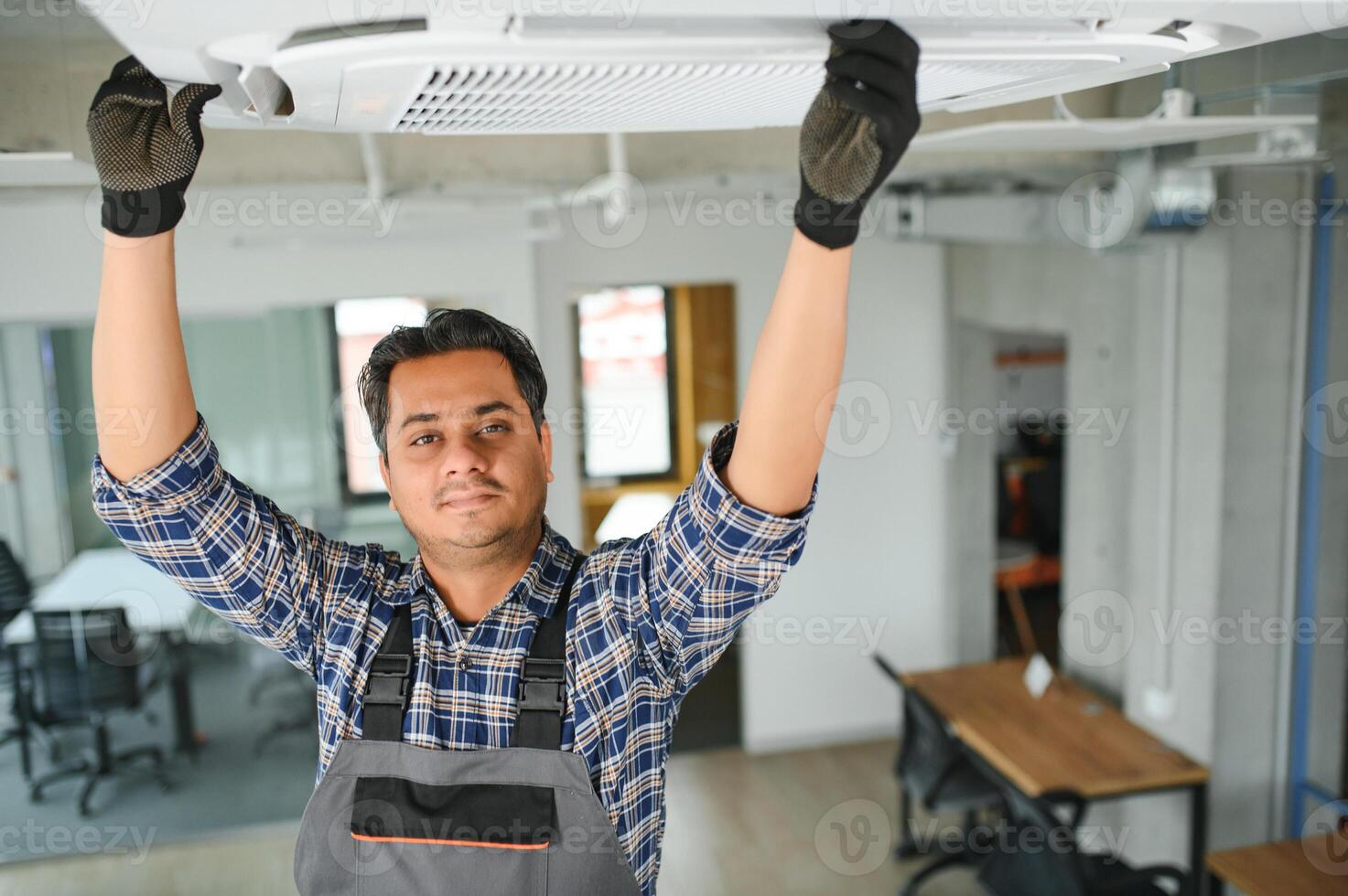 specialist cleans and repairs the wall air conditioner photo