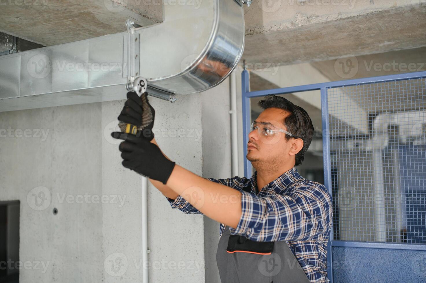 Ventilation cleaning. Specialist at work. Repair ventilation system. Industrial background photo