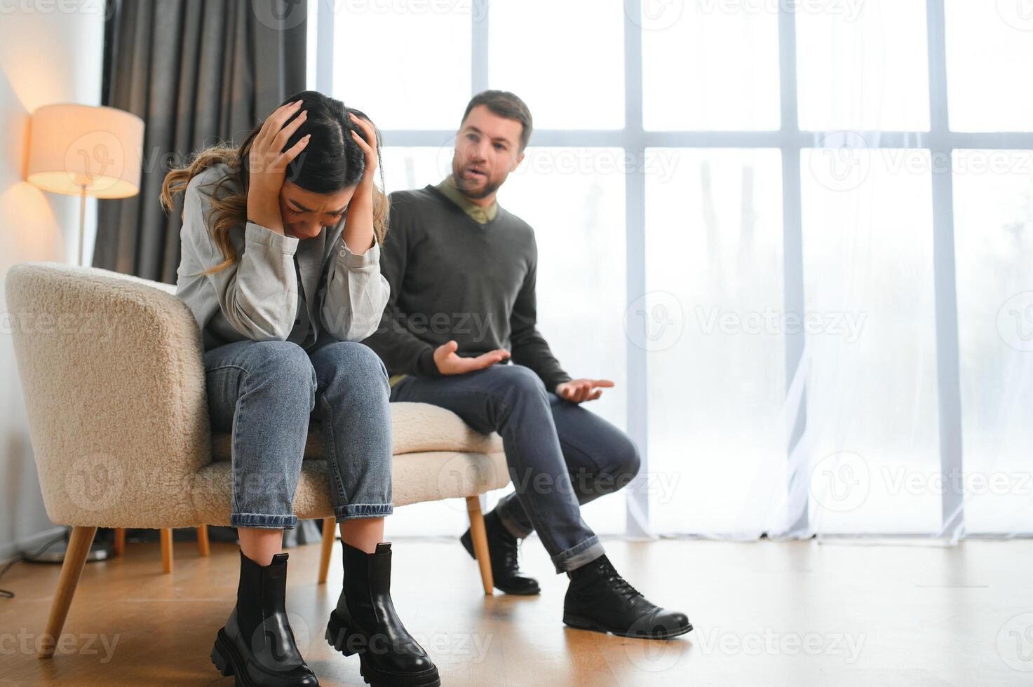 An agitated and upset husband shouts and looks at his wife, a quarrel between spouses. Family misunderstanding, quarrel photo