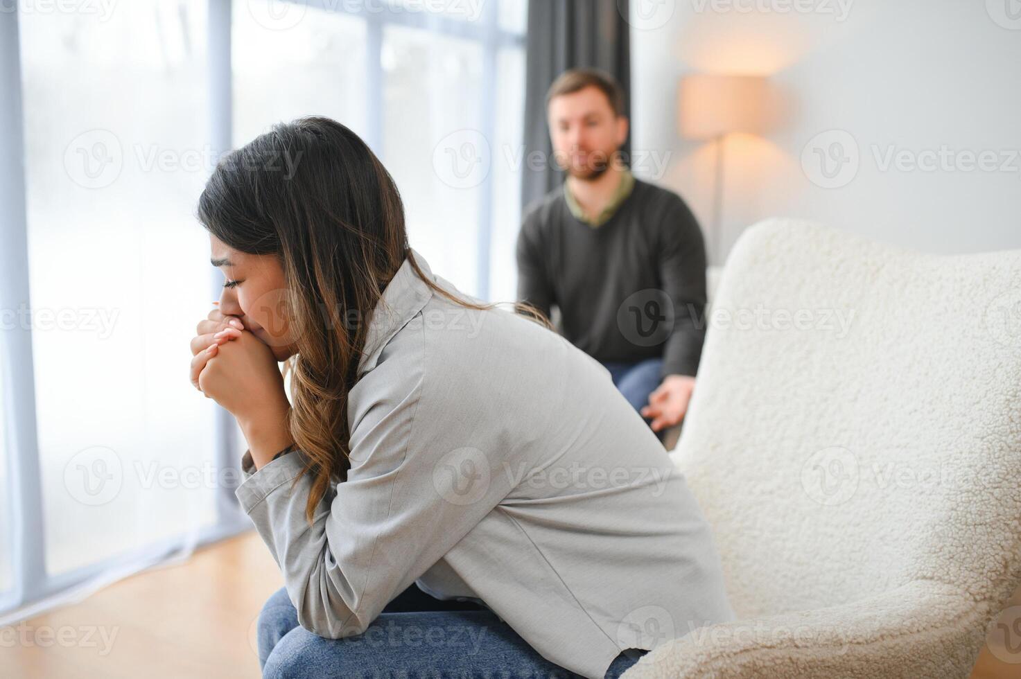 An agitated and upset husband shouts and looks at his wife, a quarrel between spouses. Family misunderstanding, quarrel photo