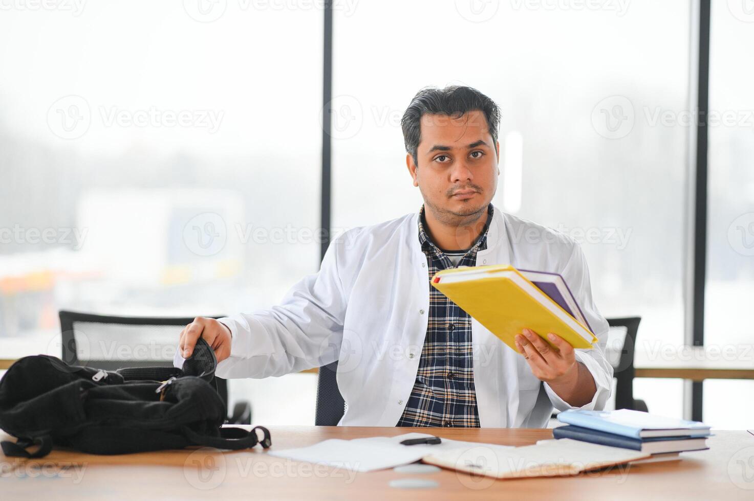Portrait of a young doctor student studying photo