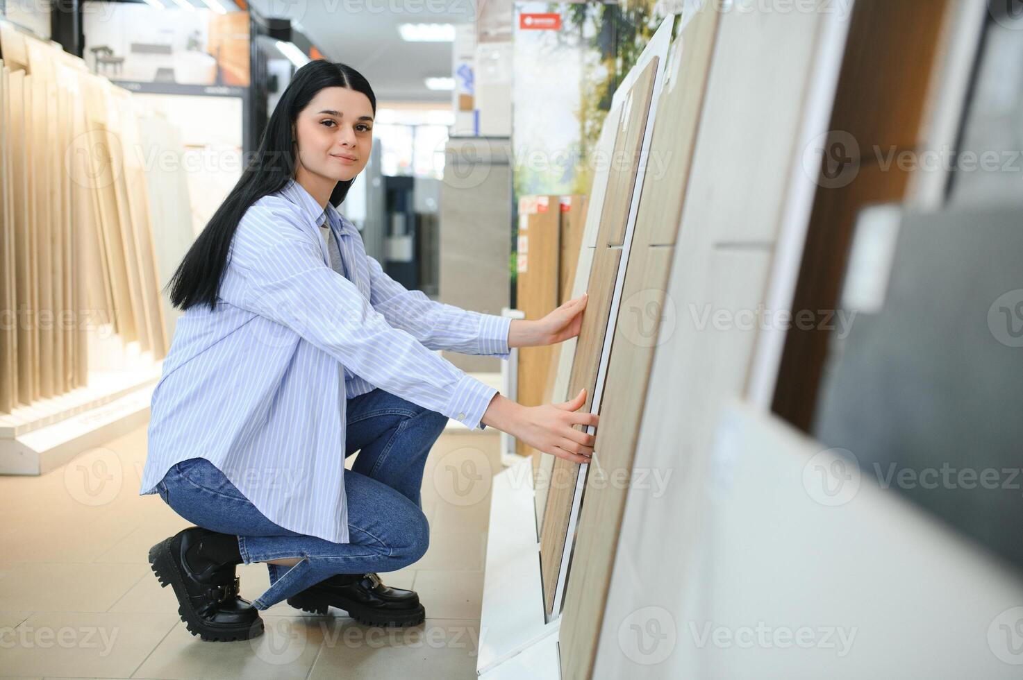 Female customer choosing kitchen ceramic tile in store photo