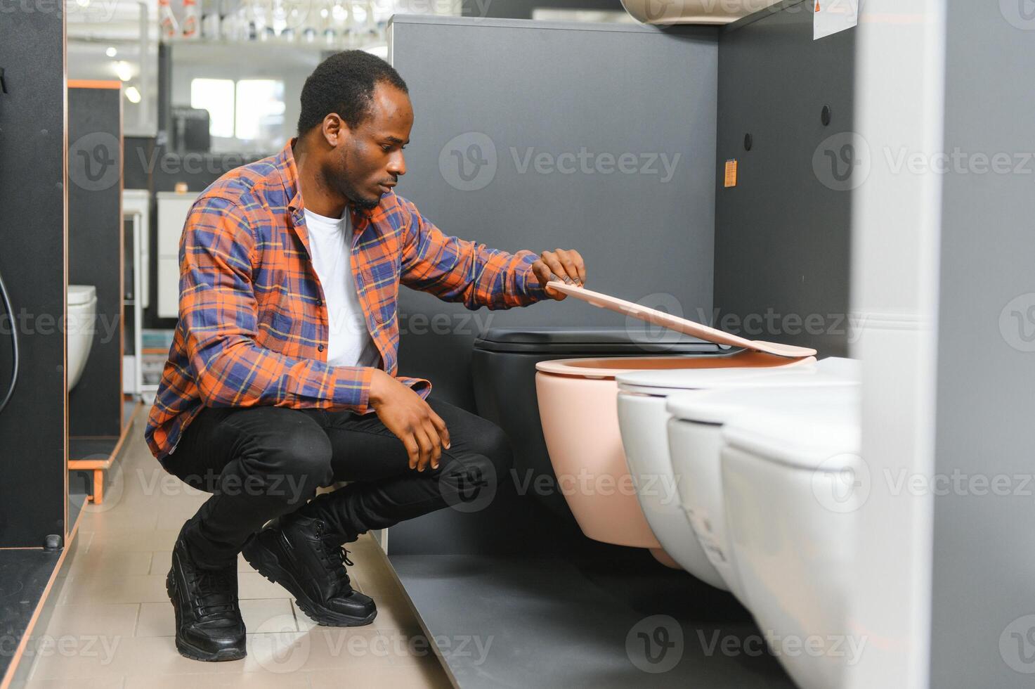 African american Man choosing home toilet in store photo