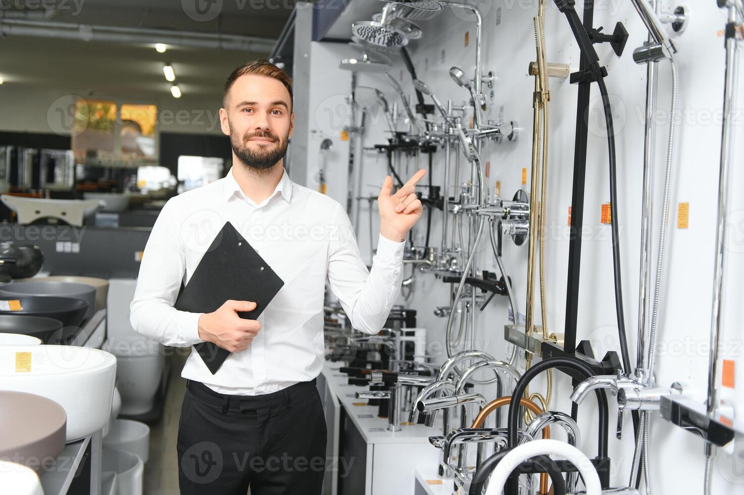 Portrait of a young man who sells faucets photo