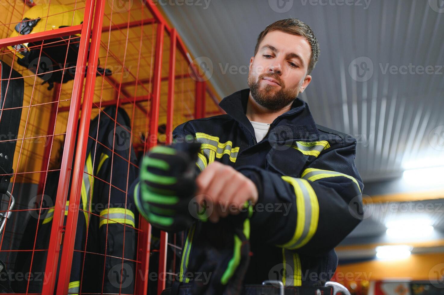 Young handsome fireman in the fire department photo