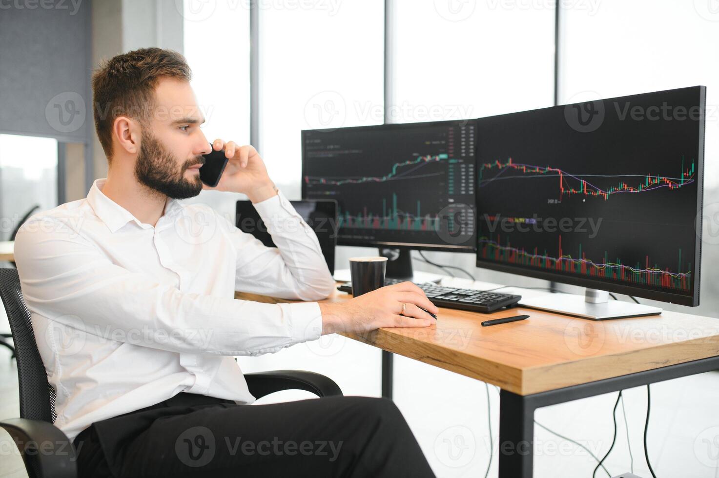 business man looking at the charts of the stock market of cryptocurrencies on the PC screen photo