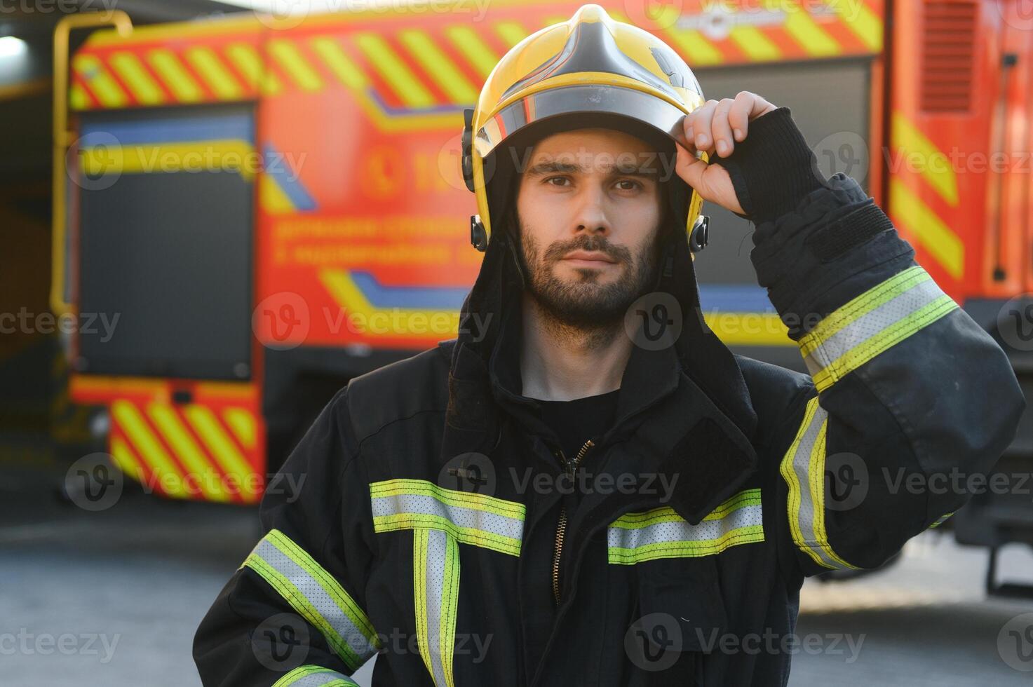 Photo of fireman with gas mask and helmet near fire engine