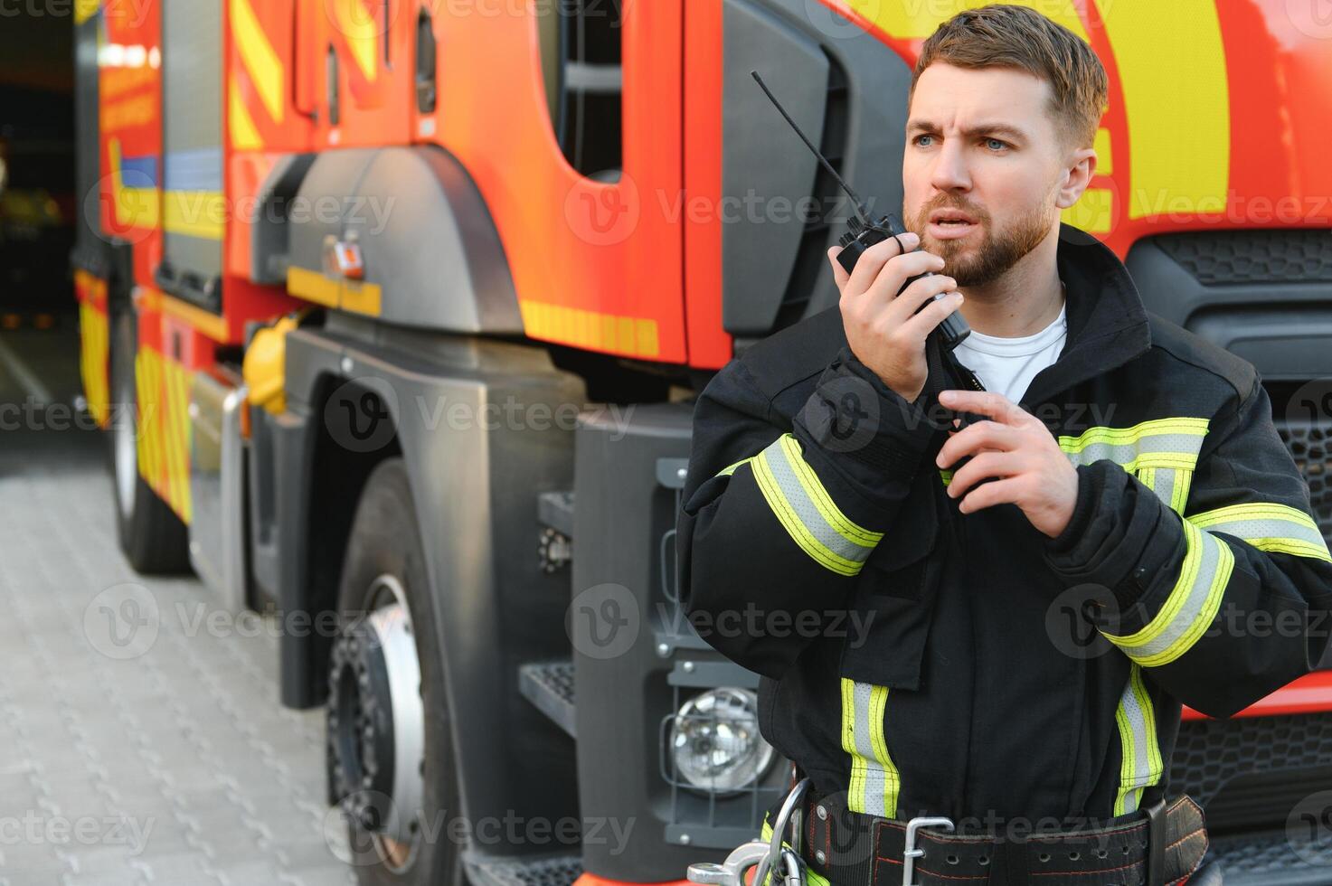 Photo of fireman with gas mask and helmet near fire engine
