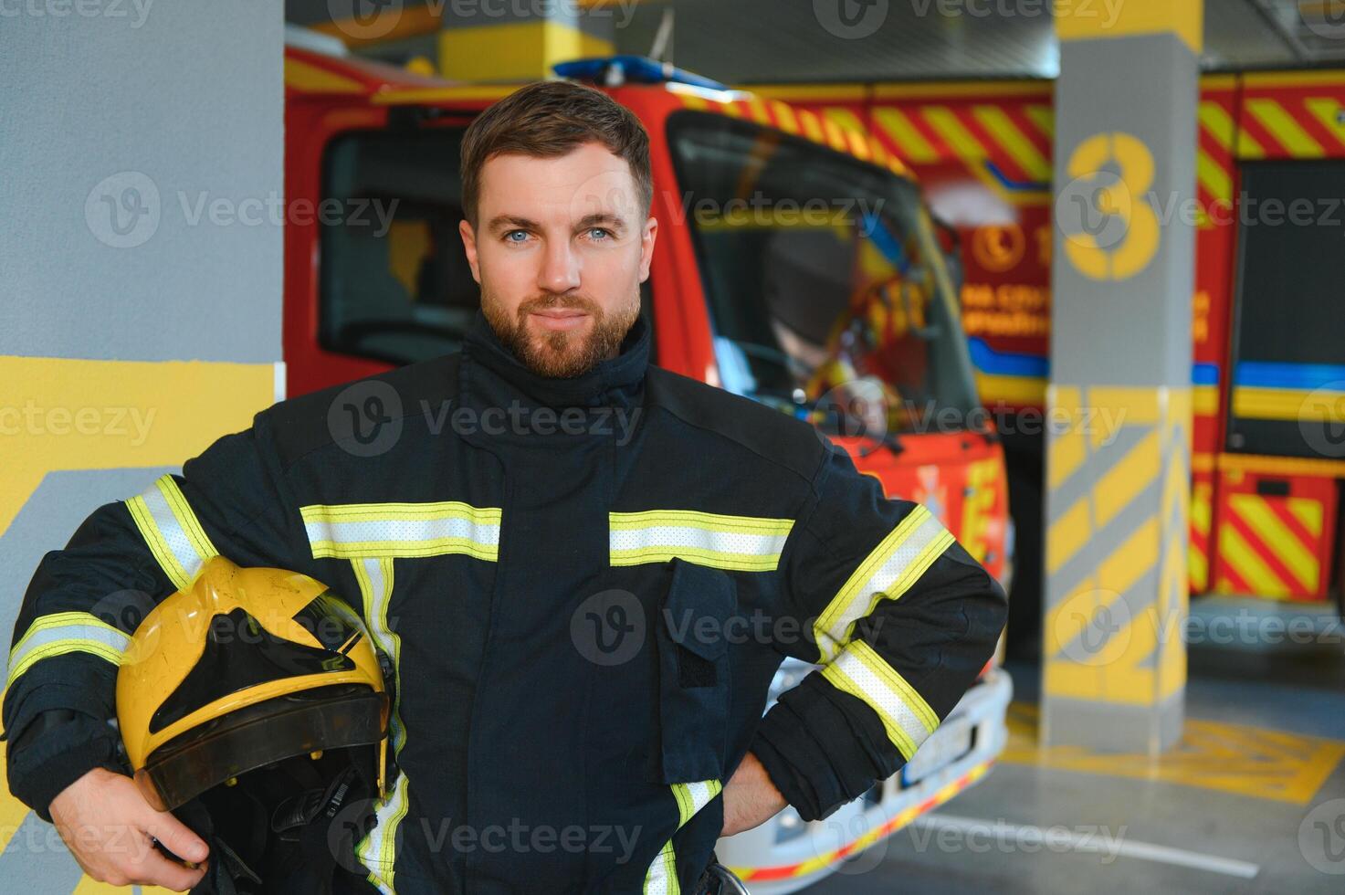Firefighters man in a protective suit near fire truck. Protection, rescue from danger. Fire station photo