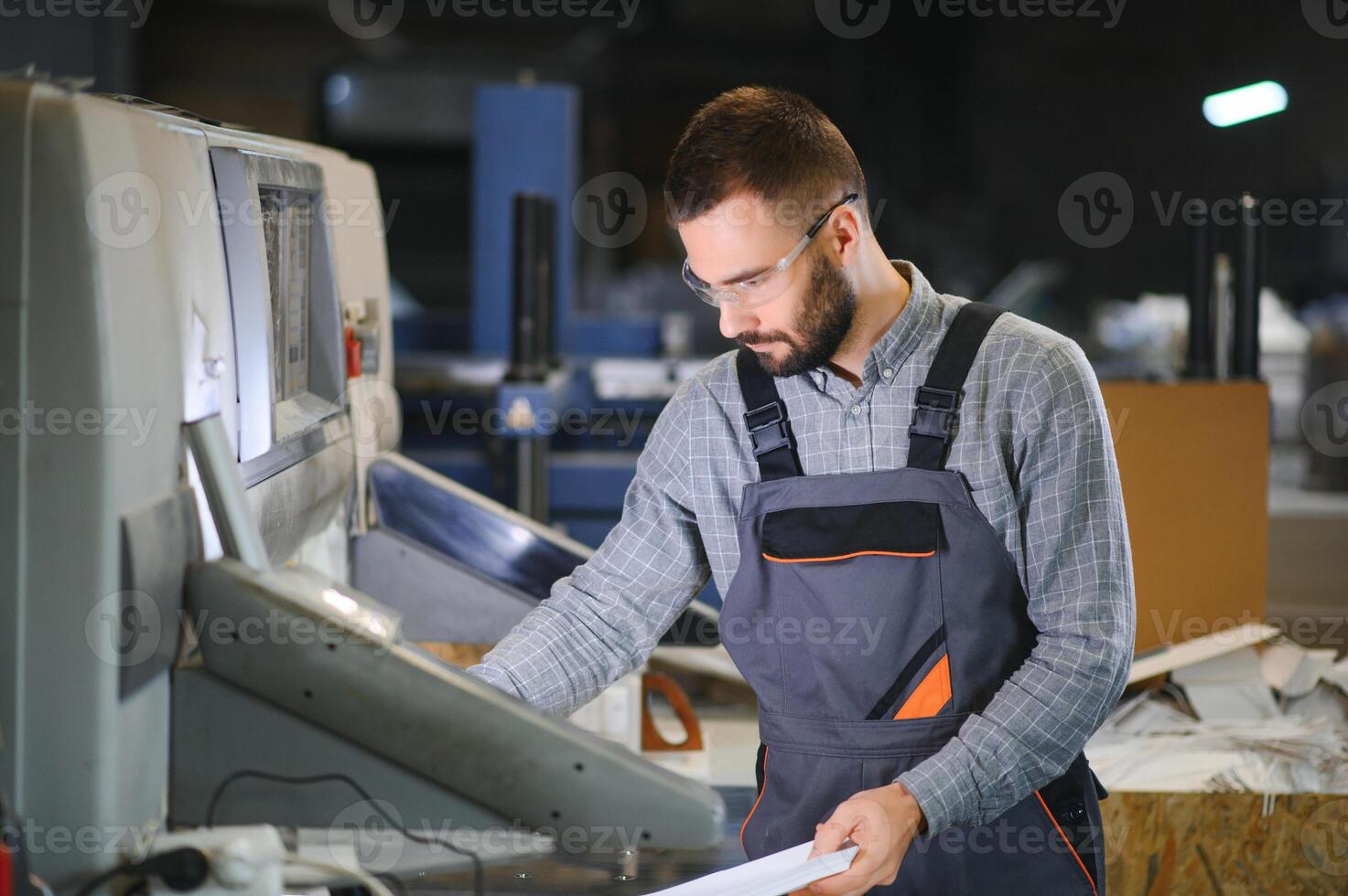 Man working in printing house with paper and paints photo