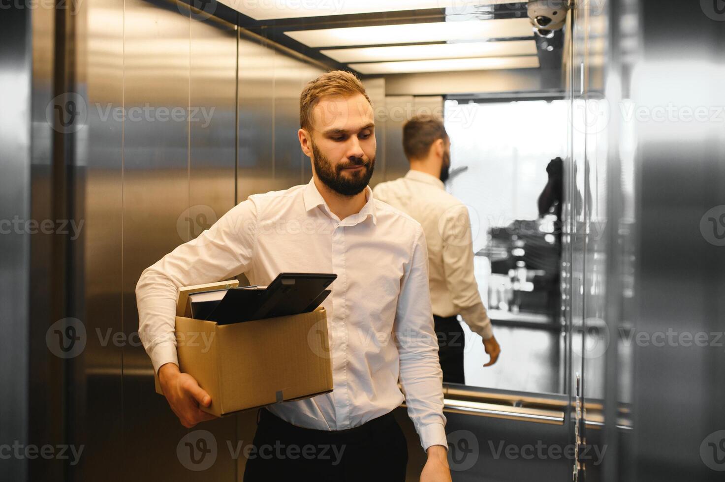 Man by dismissal. Guy lost job. Fired manager in company. Dismissal box in hands of employee. photo