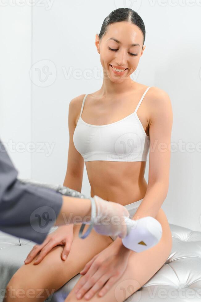 Close up Laser hair removal in the beauty salon. Woman having hands epilation. photo