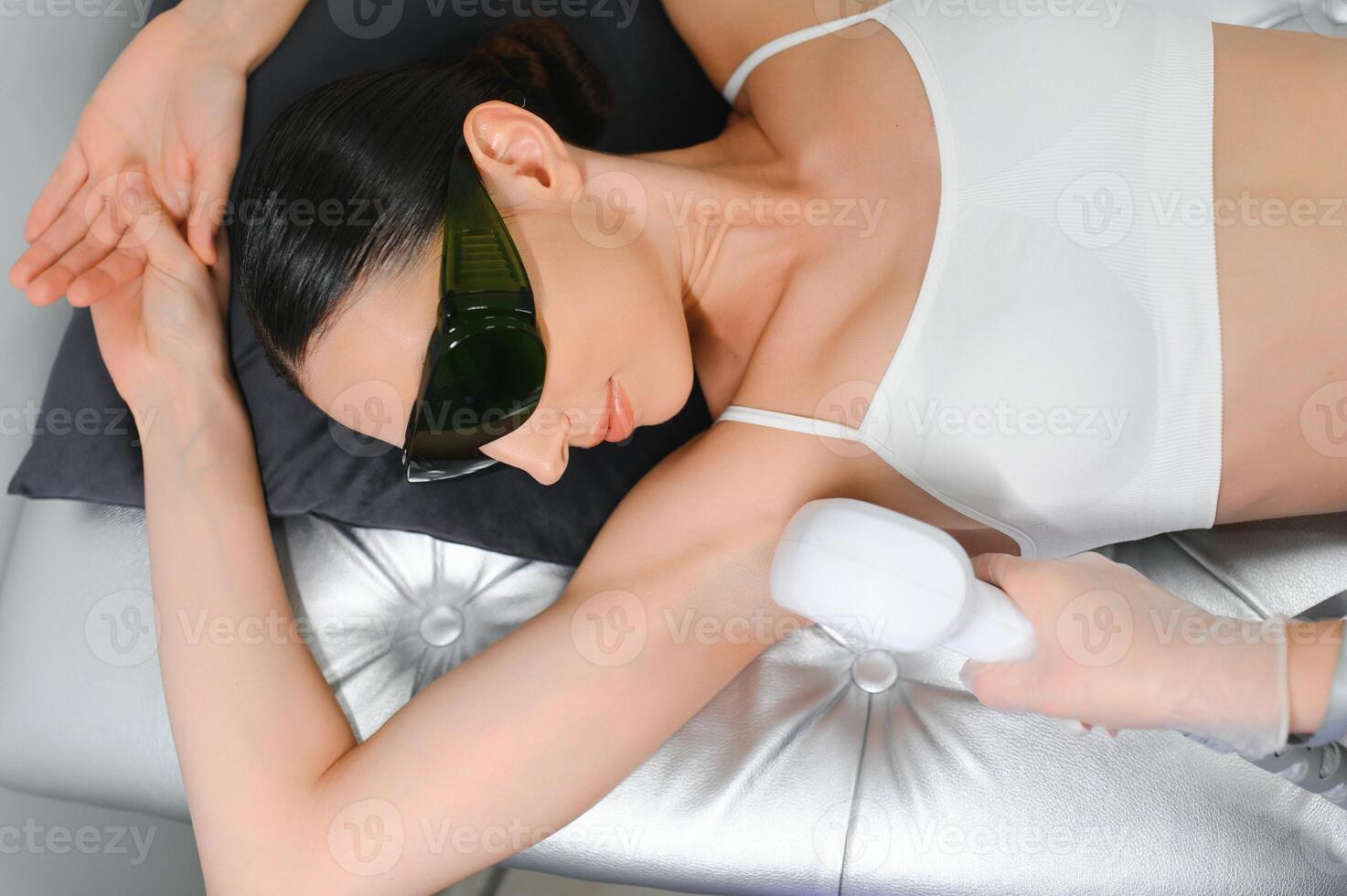 Woman getting laser treatment on her armpit in a beauty salon, close up photo