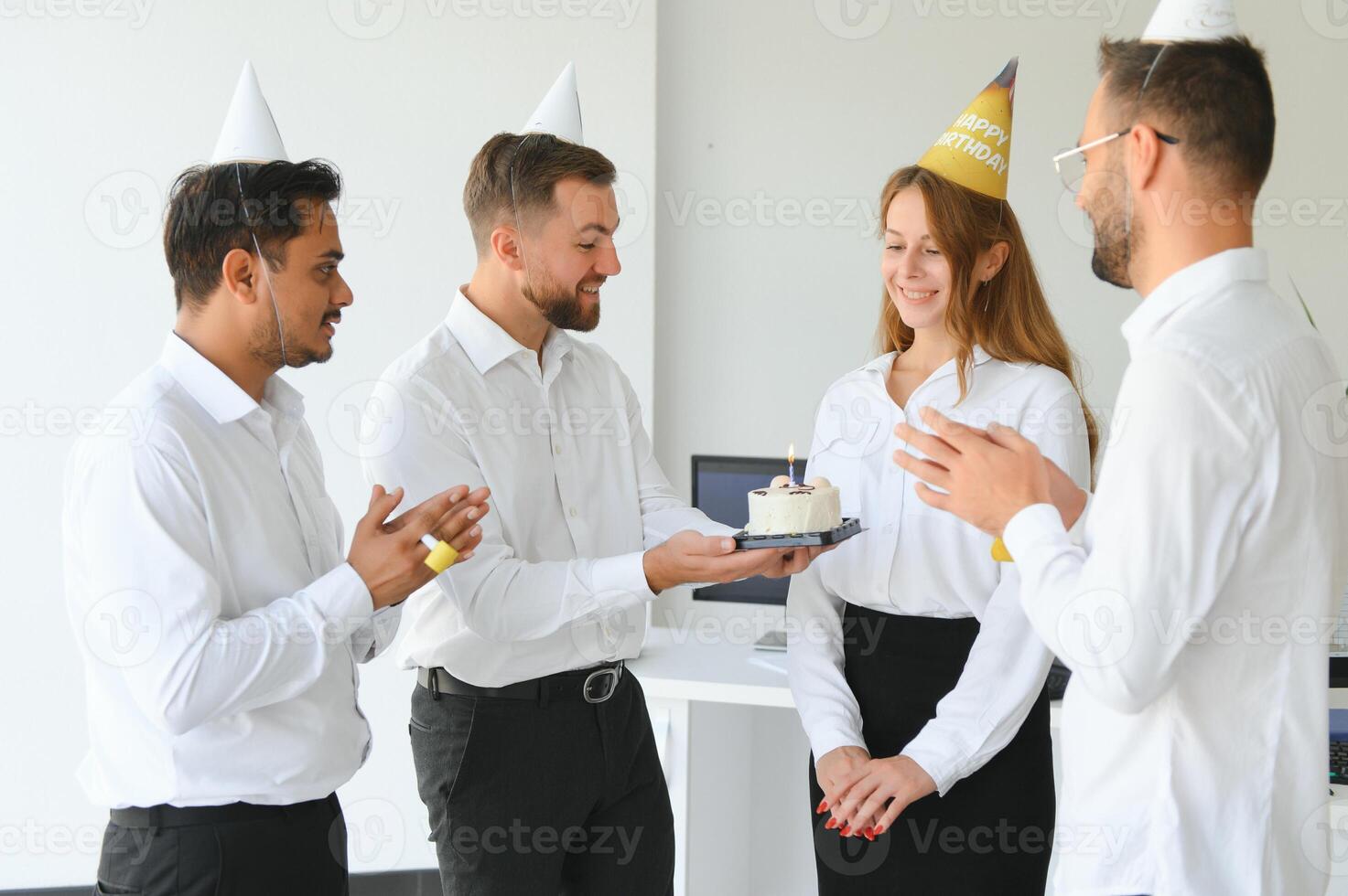 business team celebrating a birthday in the office. photo