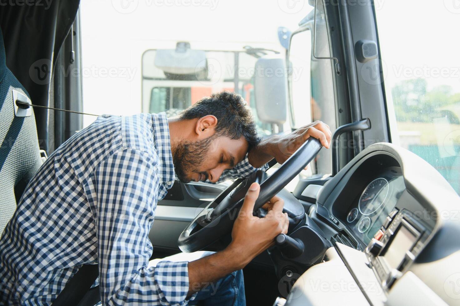 Portrait of tired indian truck driver feeling sleepy and sick photo