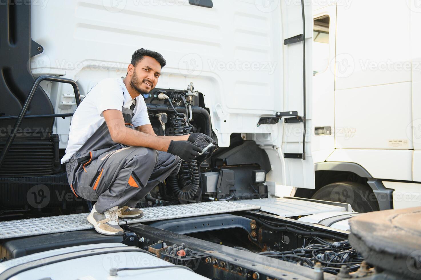 Indian Mechanic repairing the truck photo