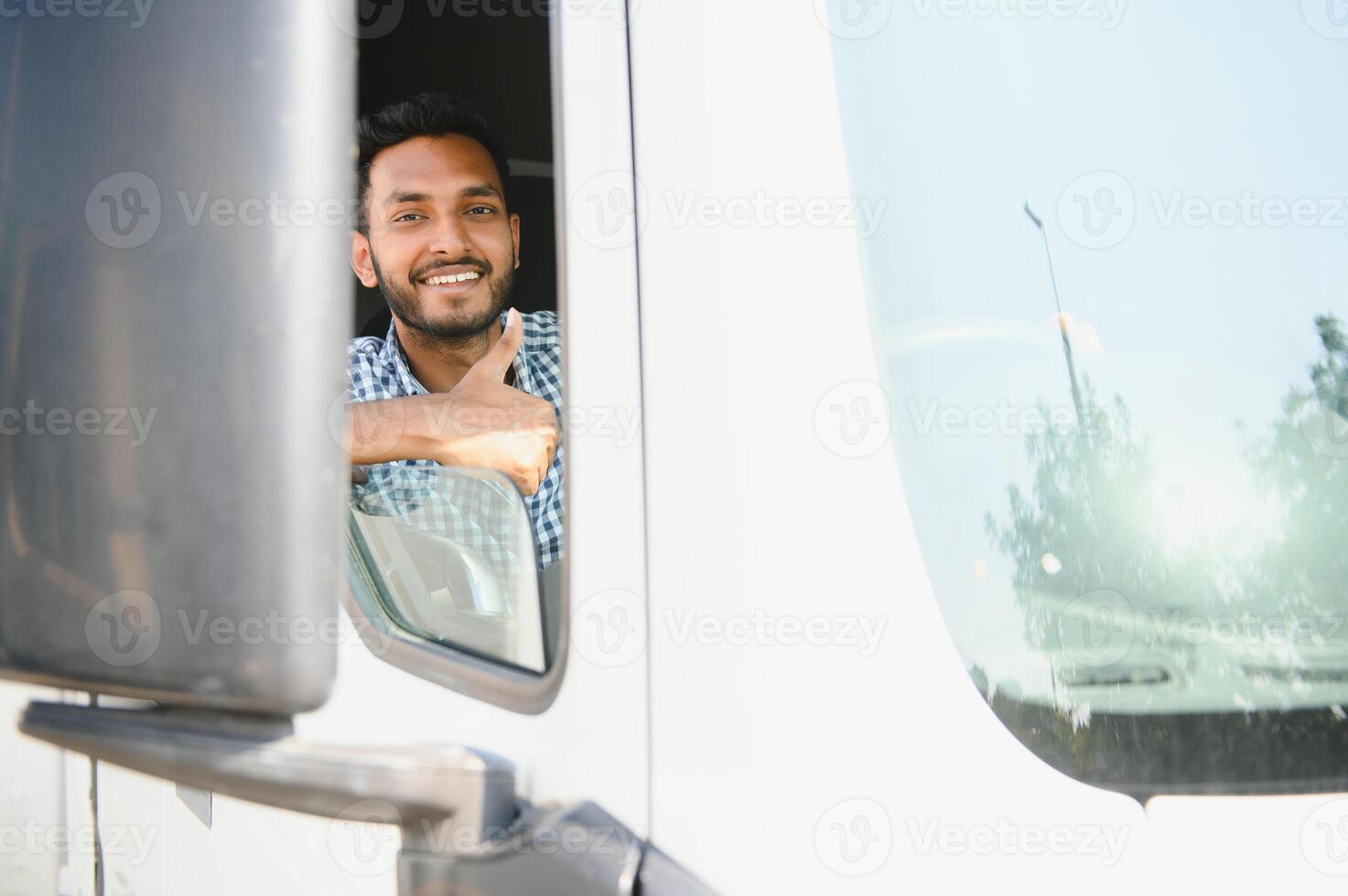 Young Indian truck driver. Concept of road freight transportation. photo