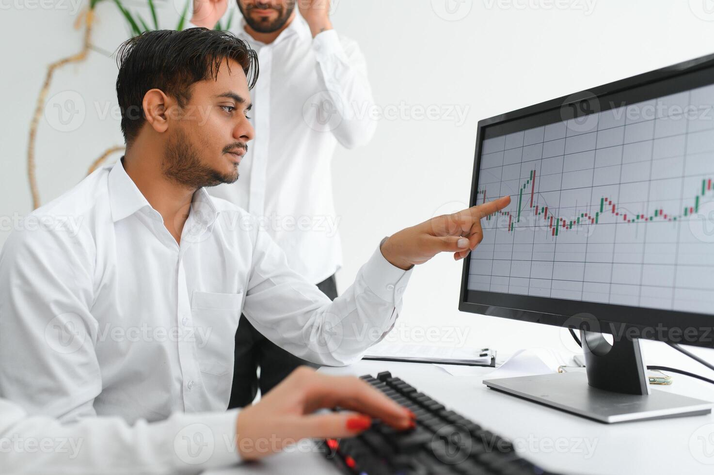 Business professionals. Group of young confident business people analyzing data using computer while spending time in the office photo