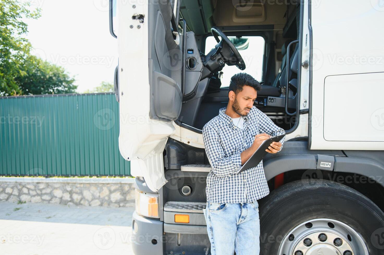 Young Indian truck driver. Concept of road freight transportation. photo