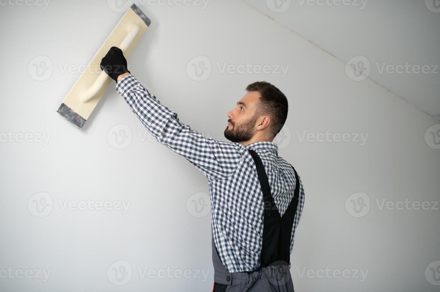 Young worker making repair in room. photo