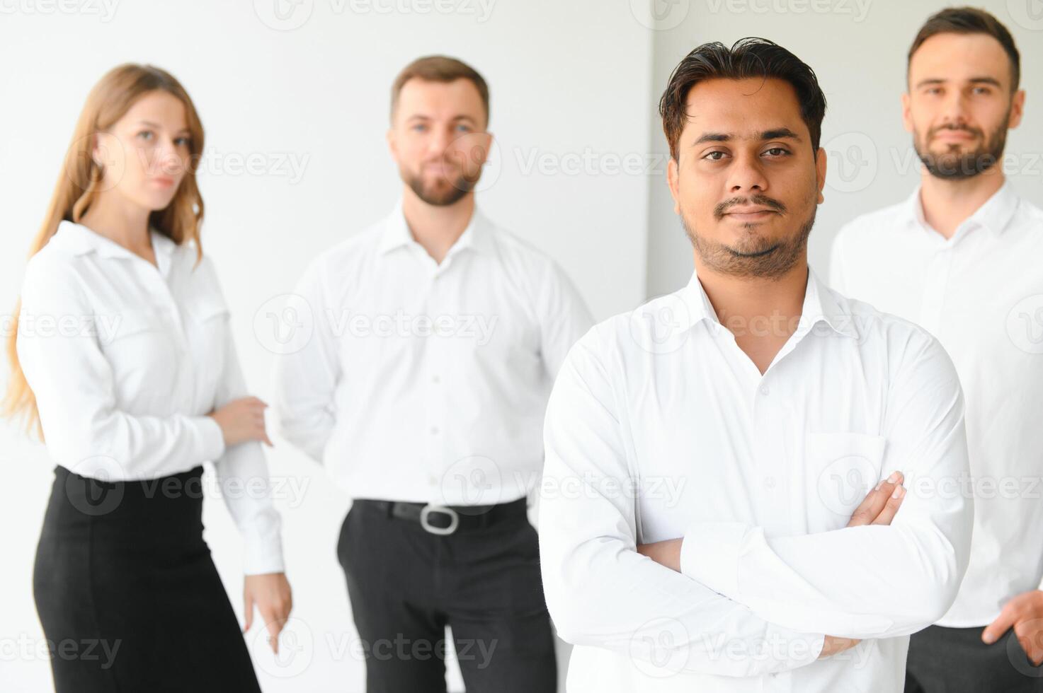 Happy businesspeople laughing while collaborating on a new project in an office. Group of diverse businesspeople working together in a modern workspace photo