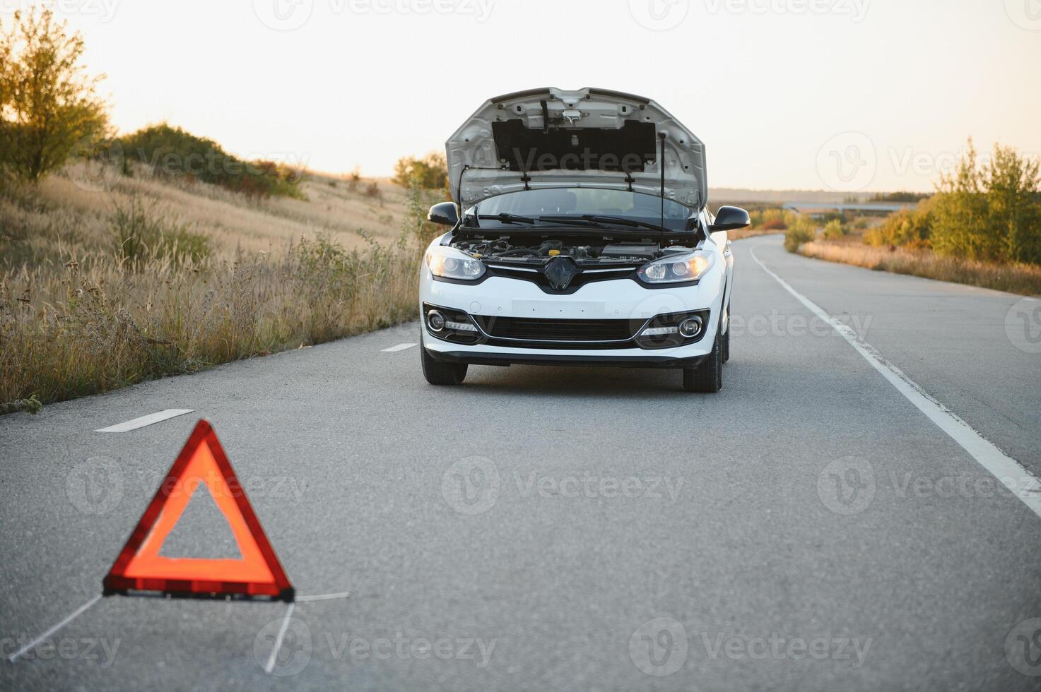 Broken car concept, breakdown triangle on road photo