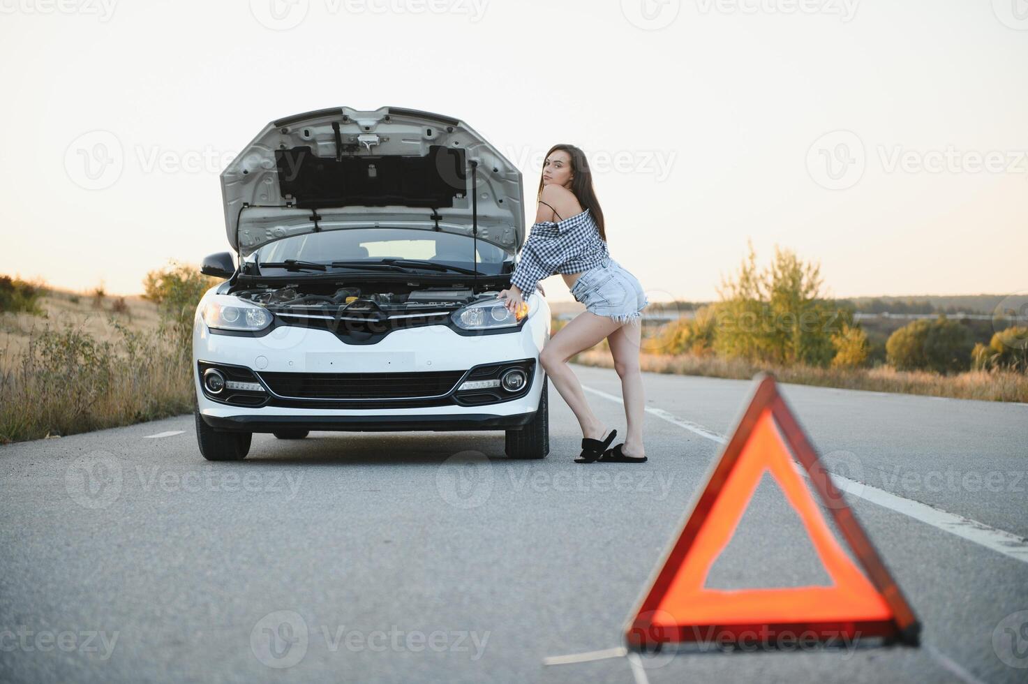 Broken car concept, breakdown triangle on road photo