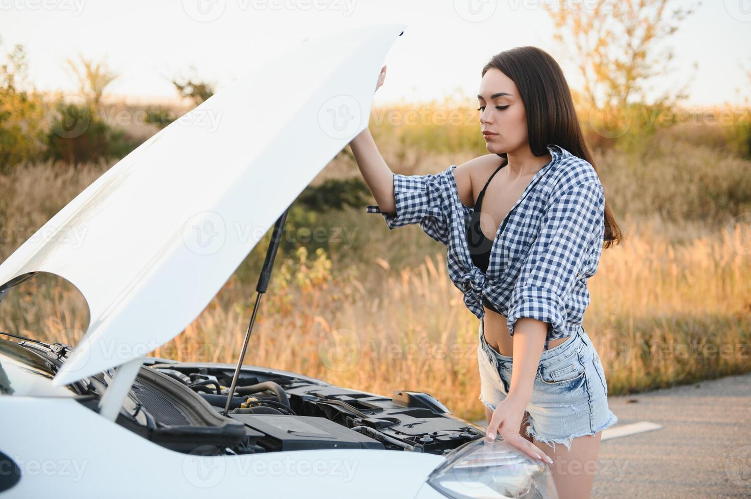 Sad woman depressed not knowing what to do with broken car photo