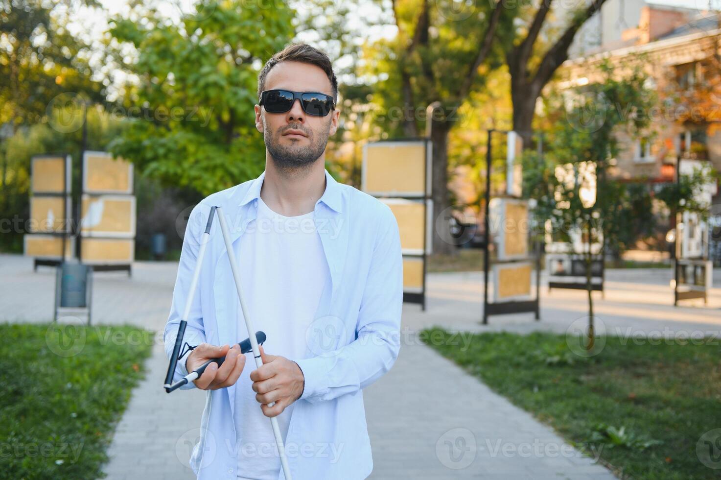 Blind man with a walking stick. photo
