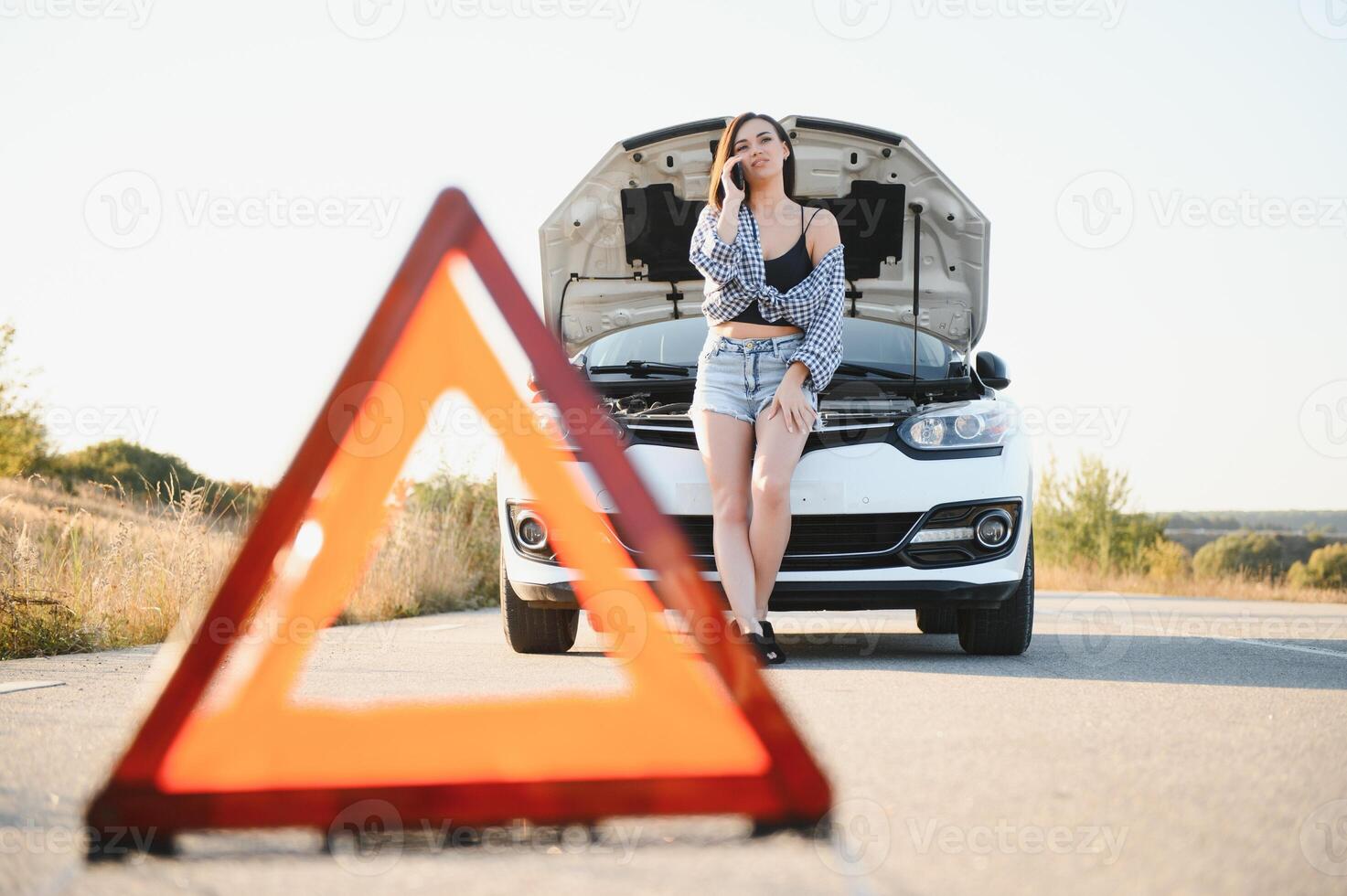 Sad woman depressed not knowing what to do with broken car photo