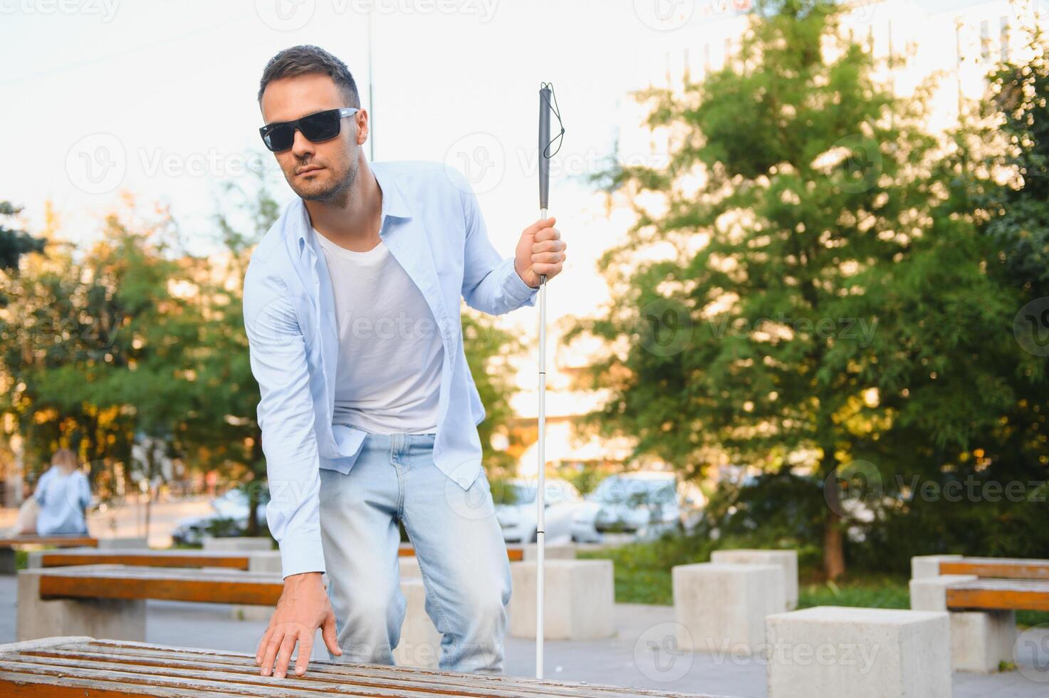 Blind man with a walking stick. photo