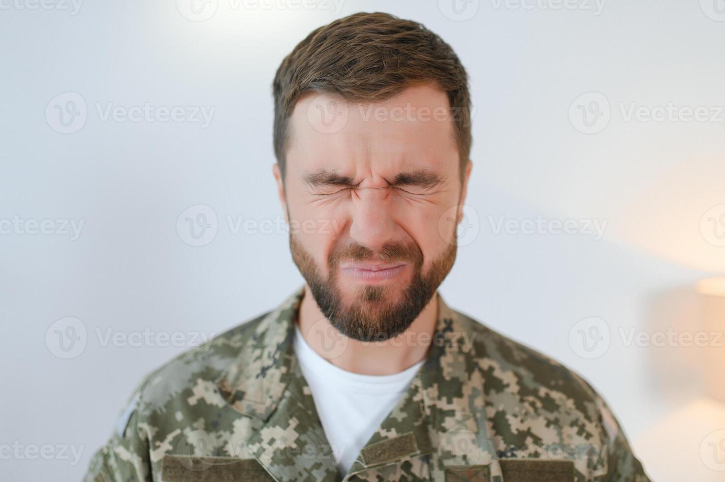 Depressed man recalling war days. Portrait of veteran soldier who has PTSD photo