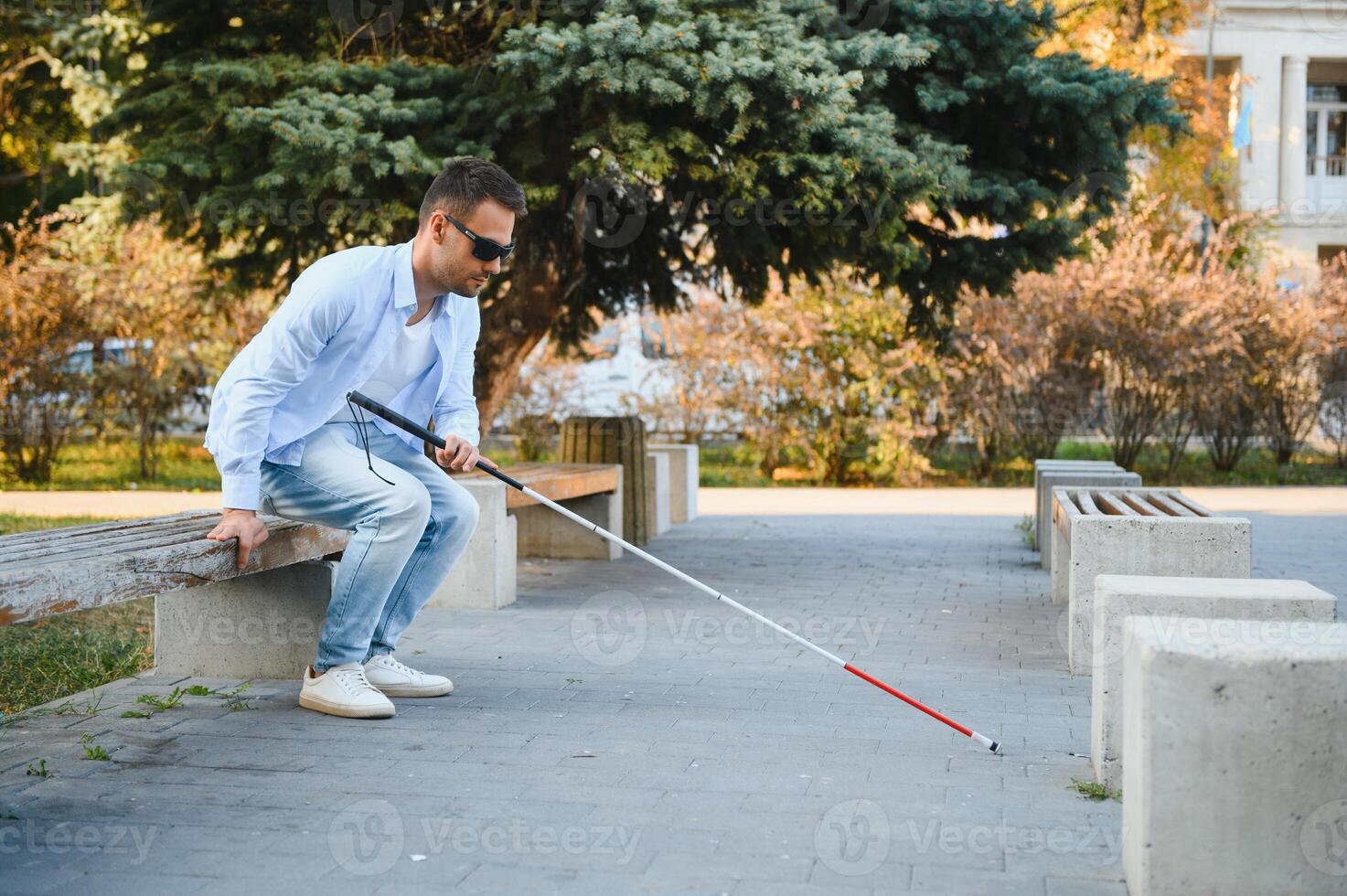 Blind man. Visually impaired man with walking stick, photo