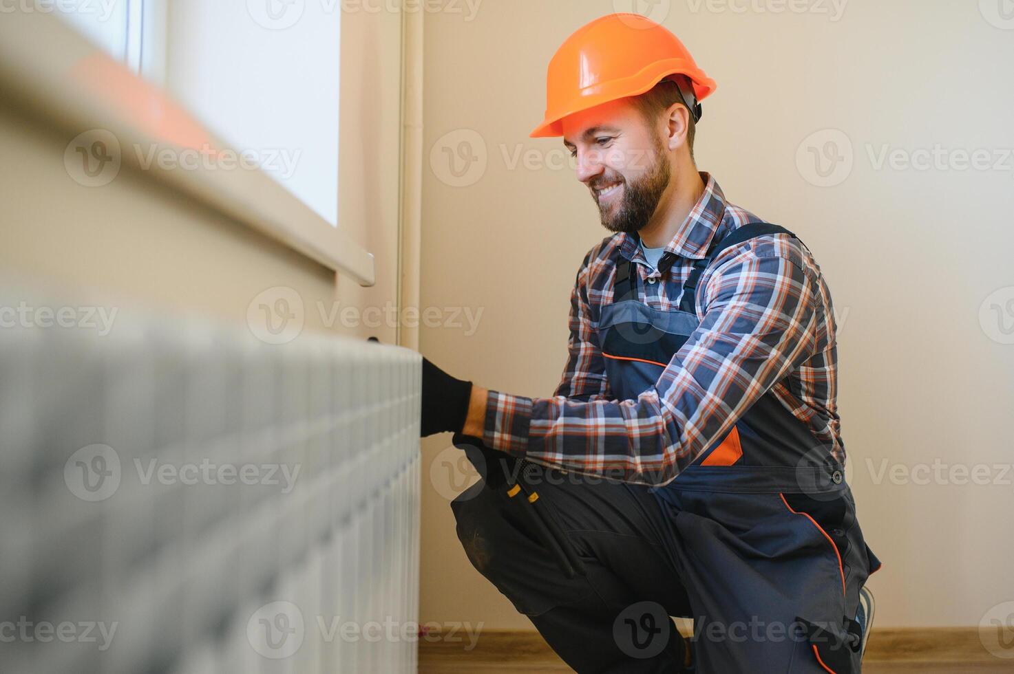 Plumber man is blocking repairs radiators of heating battery in apartment tap photo