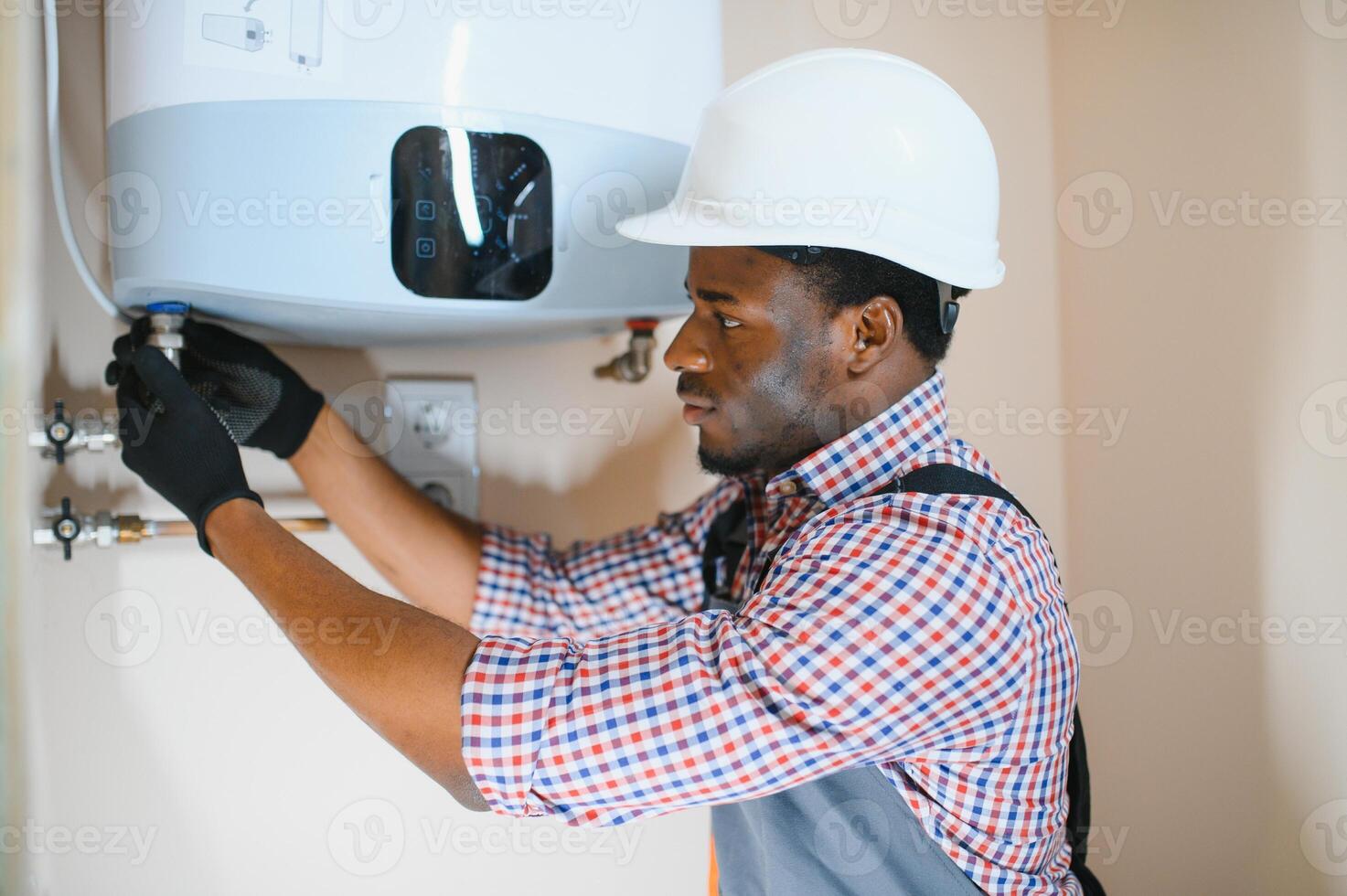 Professional engineer installing a natural gas boiler at home, he is checking the pipes photo