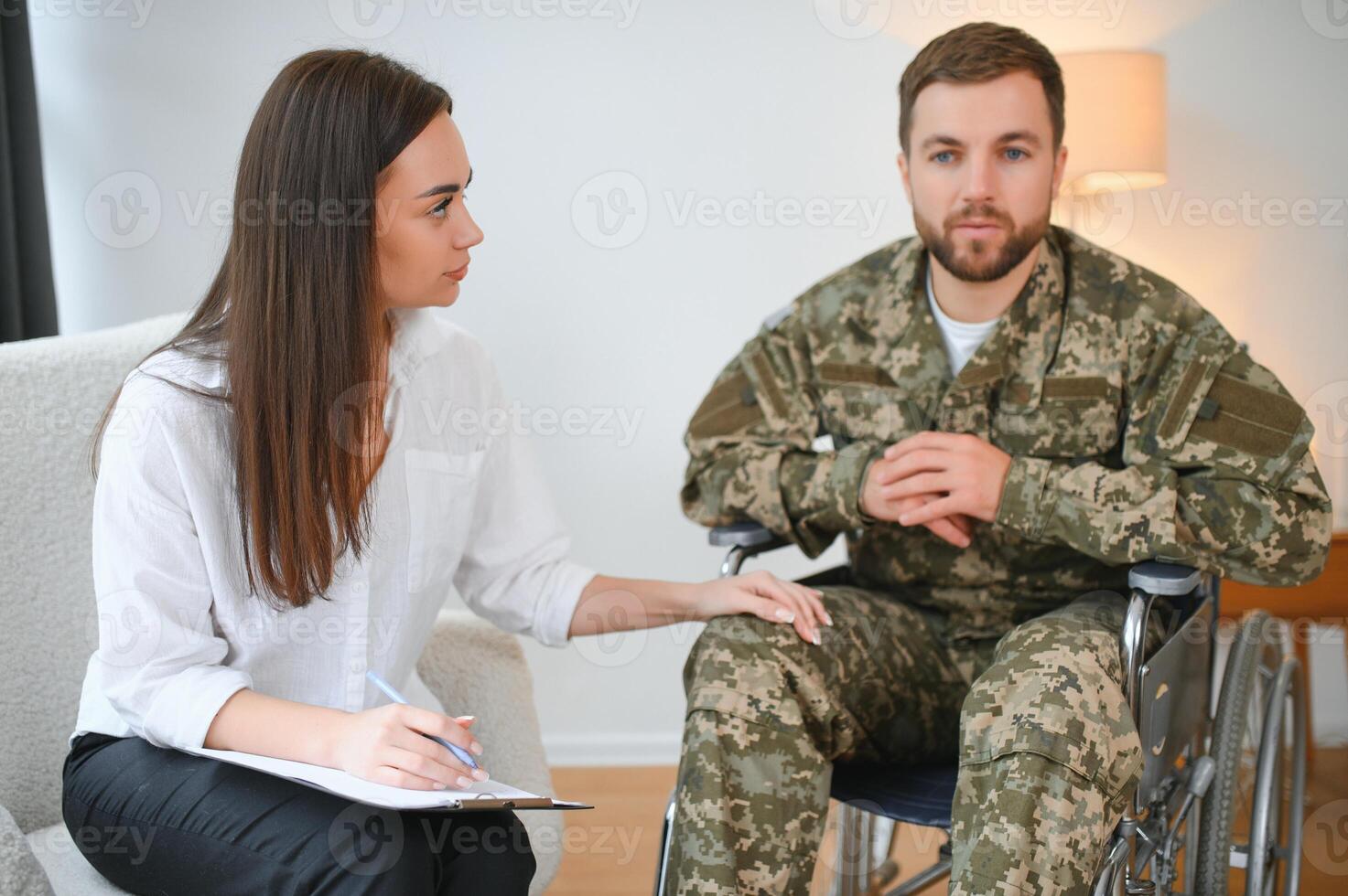 Talking to doctor. Soldier have therapy session with psychologist indoors photo