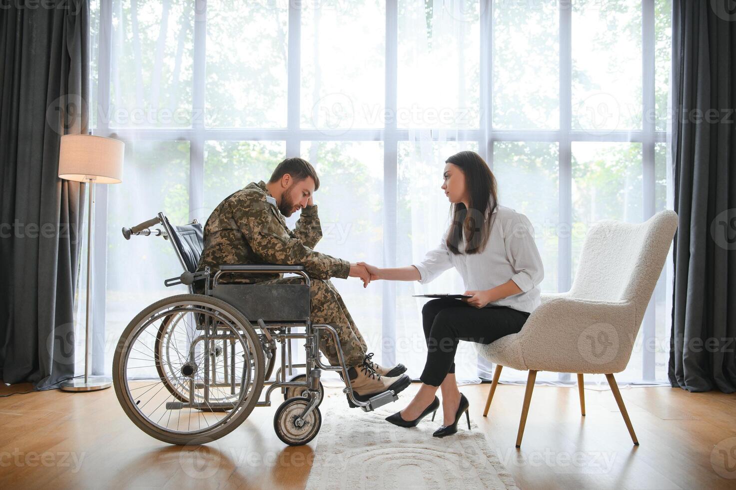 Talking to doctor. Soldier have therapy session with psychologist indoors photo