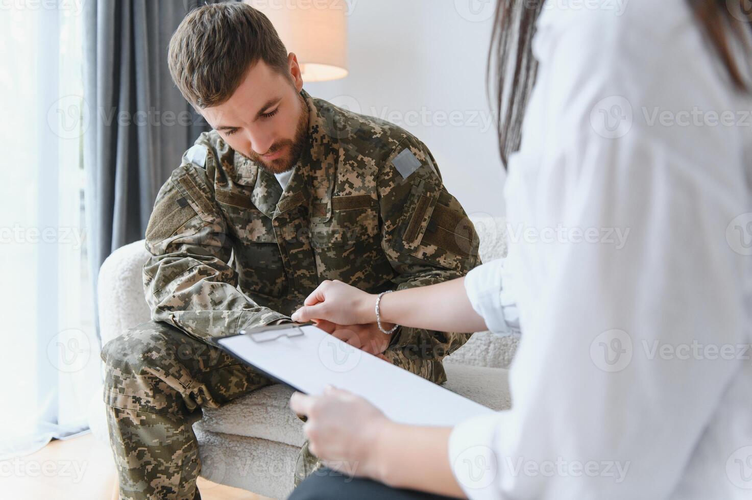 Talking to doctor. Soldier have therapy session with psychologist indoors photo