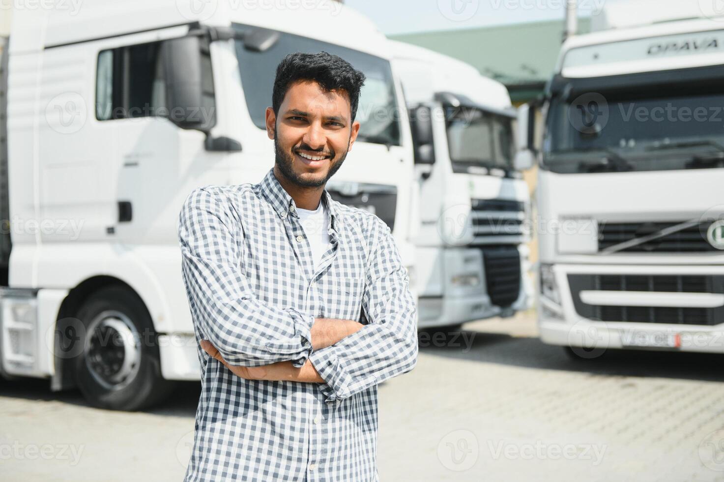 Young indian man standing by his truck. The concept of freight transportation. photo