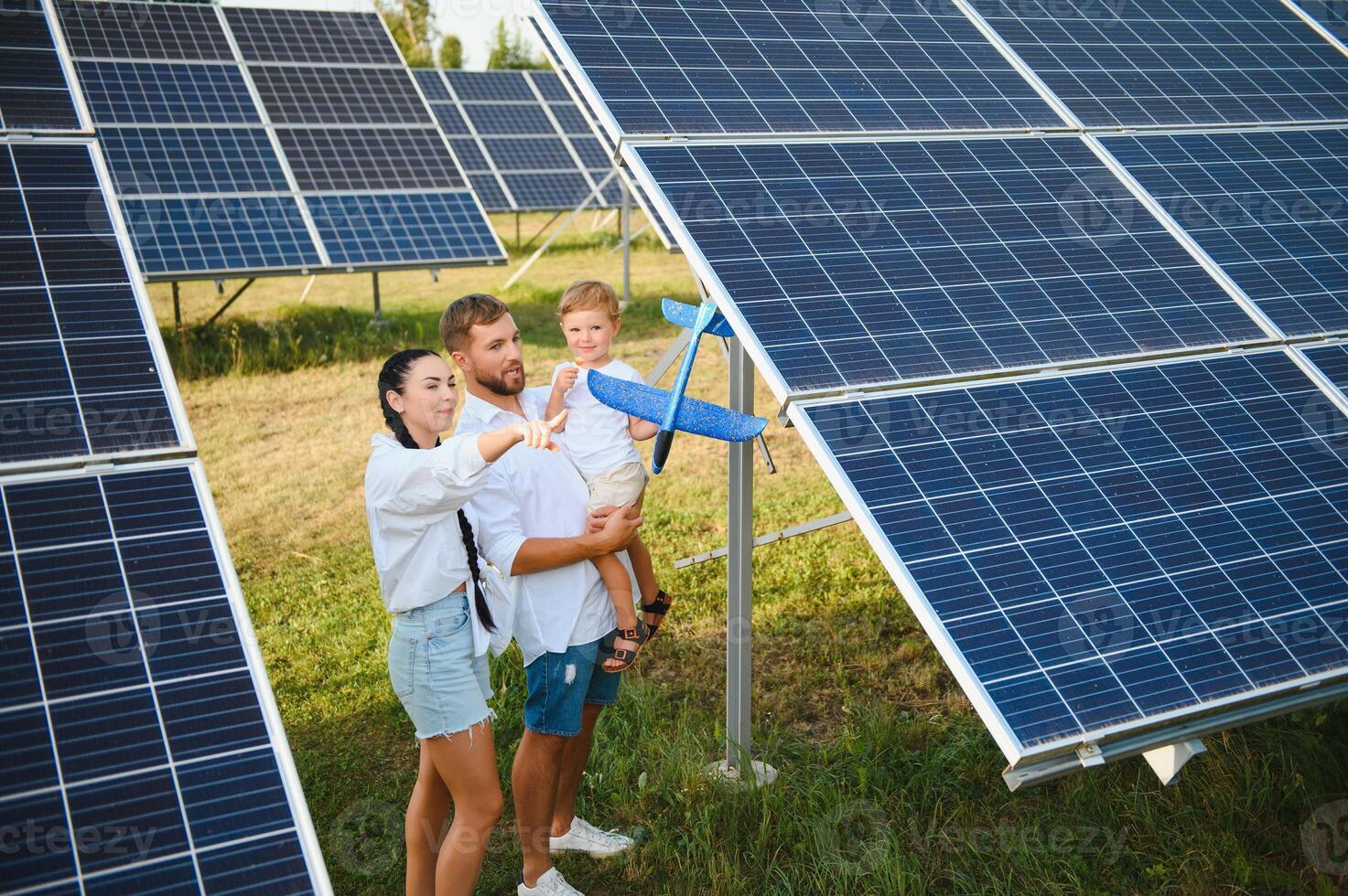 Happy family near solar panels. Alternative energy source photo