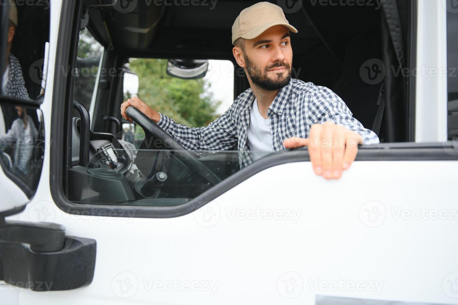 Truck driver sitting in cab photo