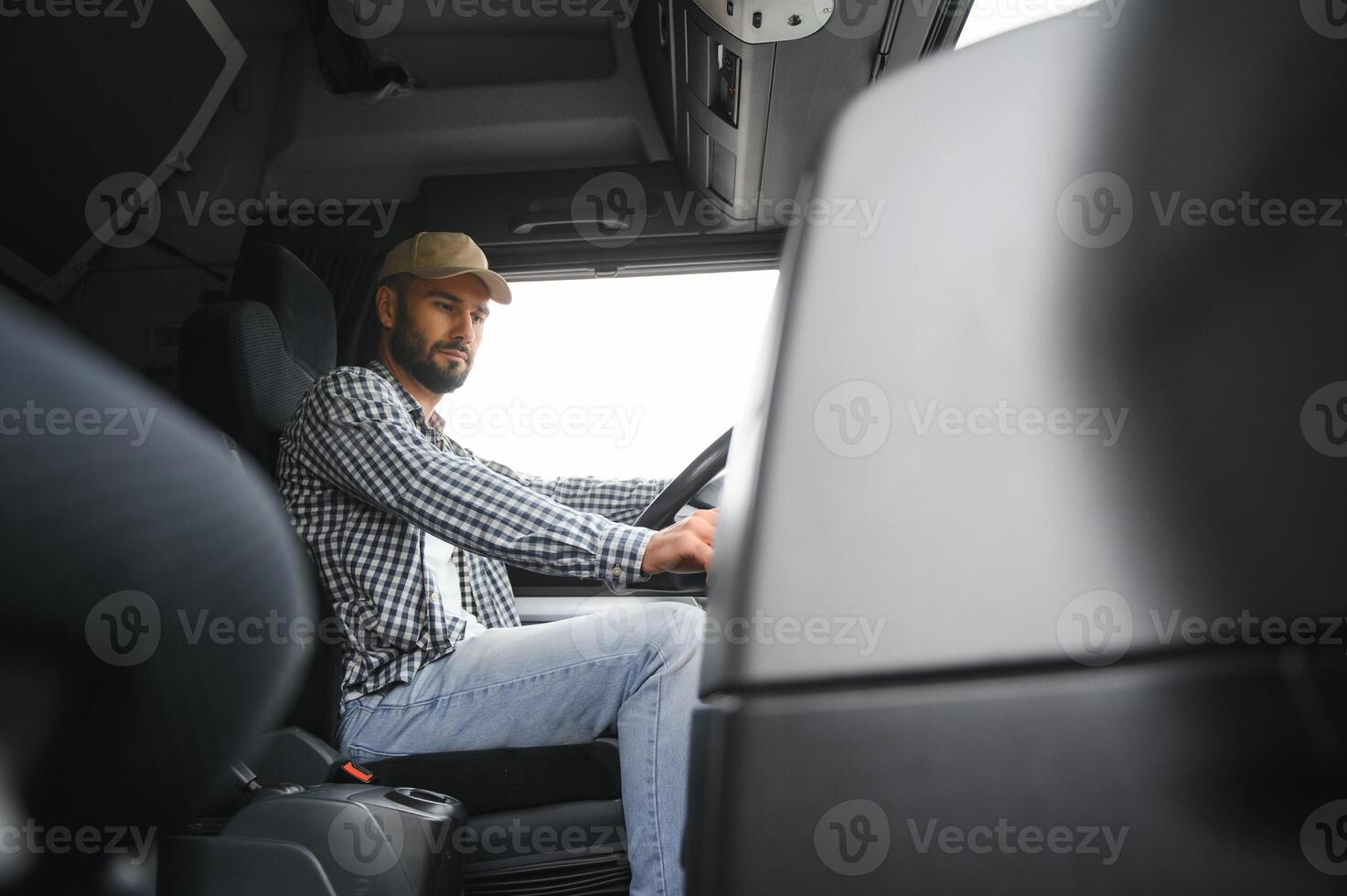 driver behind the wheel in truck cabin. photo