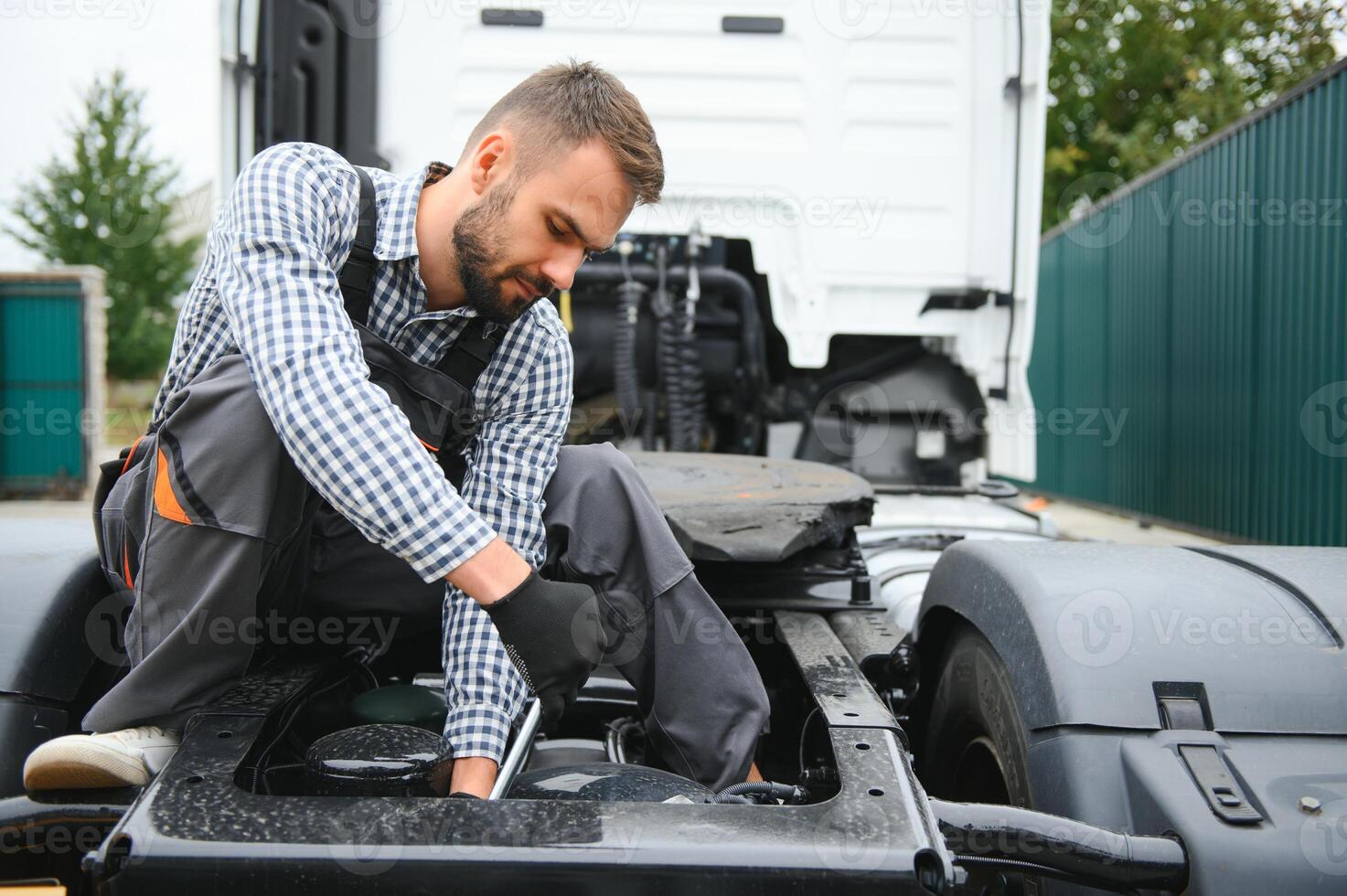 Man in uniform. Truck repair. Car malfunction. photo
