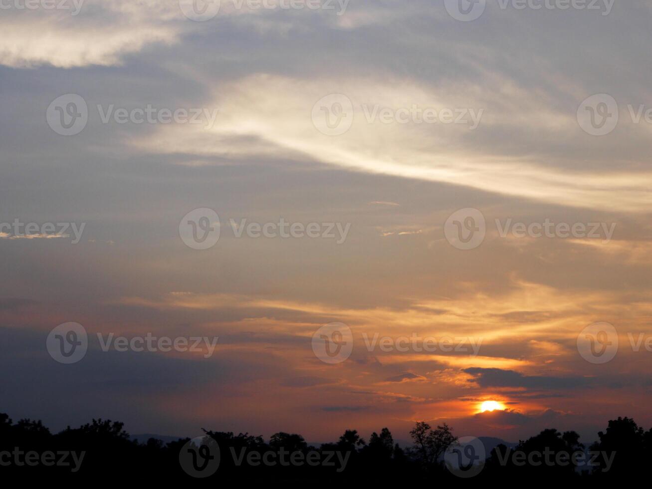 Spectacular sunset over, orange sun rising up over the horizon photo