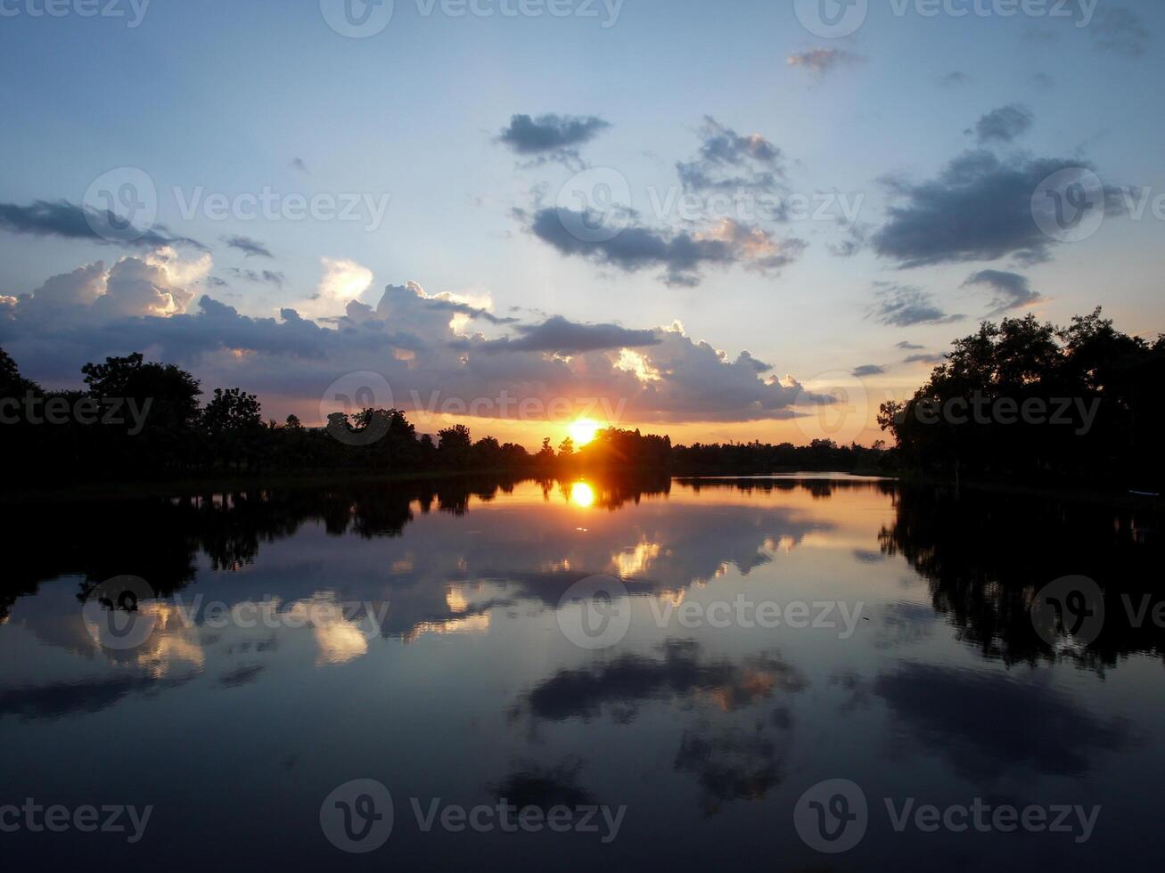 Spectacular sunset over, orange sun rising up over the horizon photo