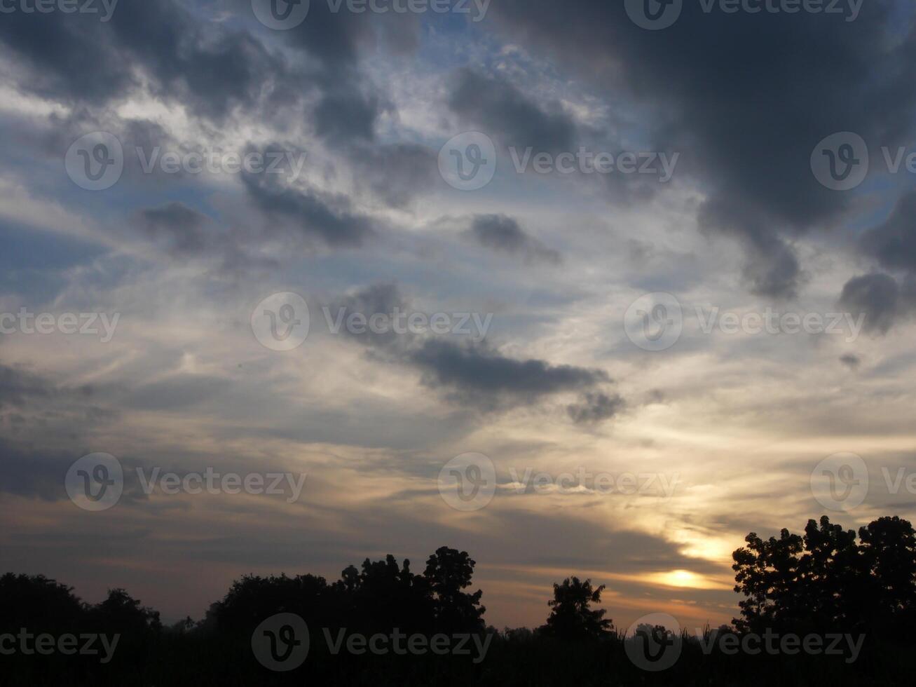 Spectacular sunset over, orange sun rising up over the horizon photo