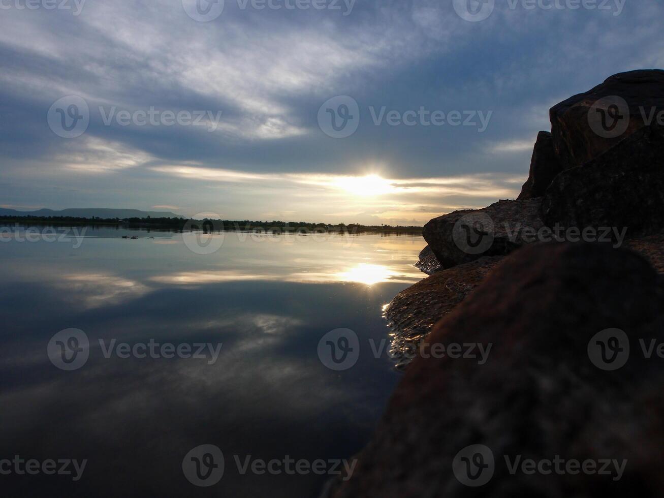 Spectacular sunset over, orange sun rising up over the horizon photo